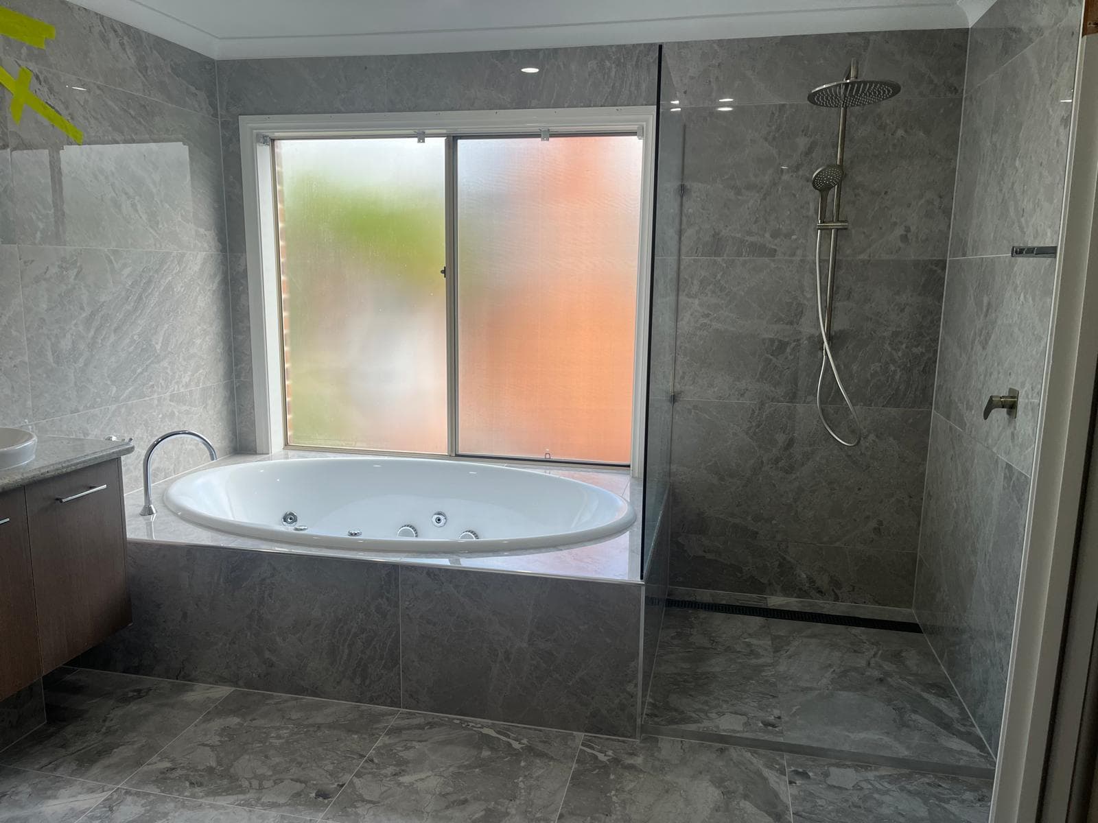 Bathroom tiling around bath by Diamond VIC Tiling